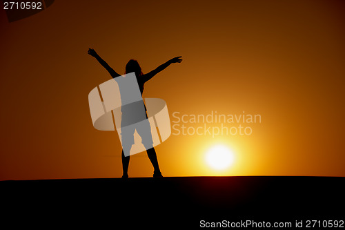 Image of Person enjoys to the sun at sunset