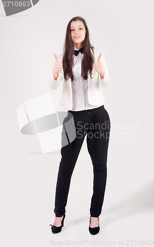Image of Smiling businesswoman with thumbs up gesture