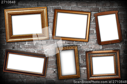Image of messy arrangement of frames on wall