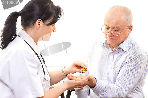Image of Doctor giving the medicine to a senior man
