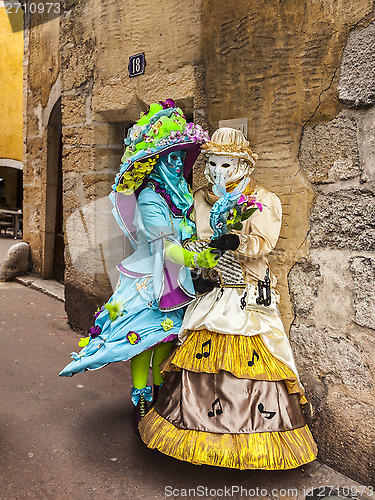 Image of Two Disguised Persons on a Narrow Street