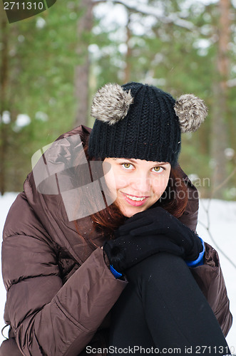 Image of Portrait of the charming young woman in winter outdoors 