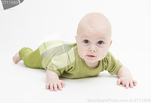 Image of curious toddler in green clothing