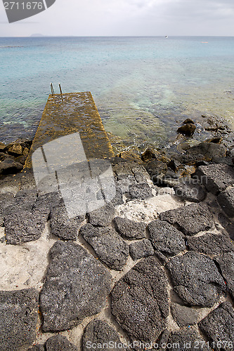 Image of pier rusty chain  water  boat yacht   spain