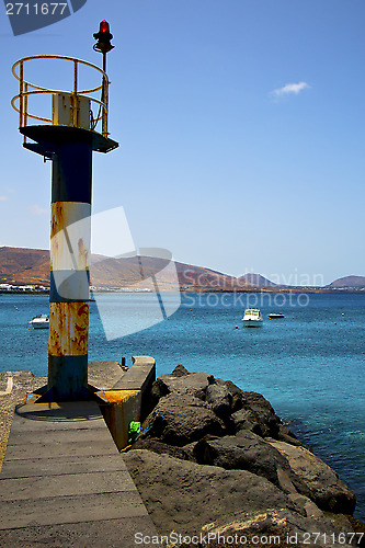 Image of spain lighthouse and harbor pier boat in the 