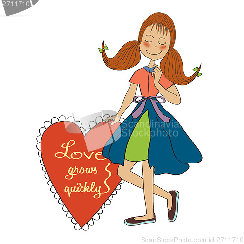 Image of Girl in love holding a heart