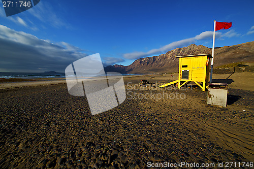 Image of lifeguard chair red flag in spain  lanzarote  rock stone sky clo