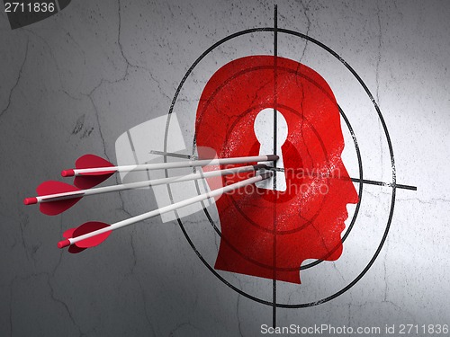 Image of Information concept: arrows in Head With Keyhole target on wall background