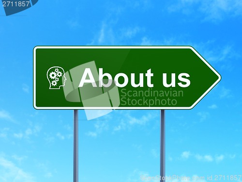 Image of Marketing concept: About Us and Head With Gears on road sign background