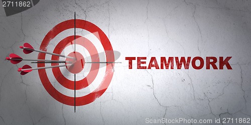 Image of Business concept: target and Teamwork on wall background