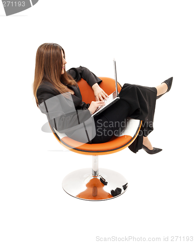 Image of elegant businesswoman with laptop in orange chair