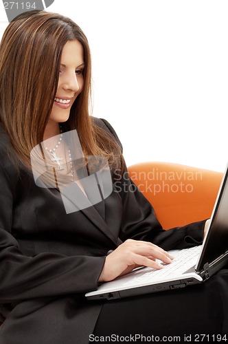 Image of portrait of businesswoman with laptop in orange chair
