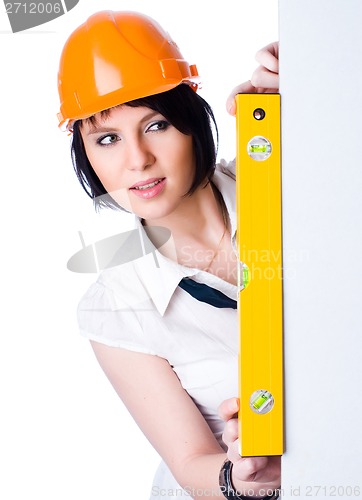 Image of Pretty girl in helmet with level