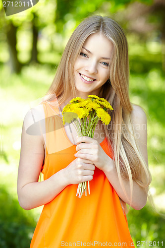 Image of Spring girl with bunch of dandelions