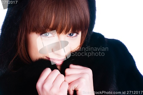 Image of Young woman in fur coat