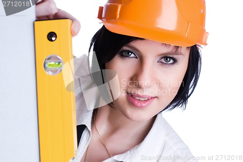 Image of Pretty girl in helmet with level