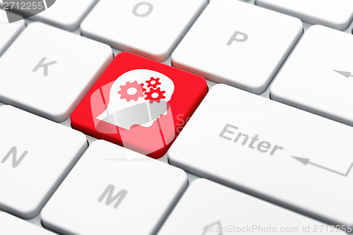 Image of Education concept: Head With Gears on computer keyboard background