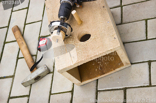 Image of Drilling holes in the birdhouse