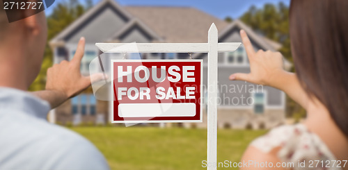 Image of For Sale Sign, House and Military Couple Framing Hands