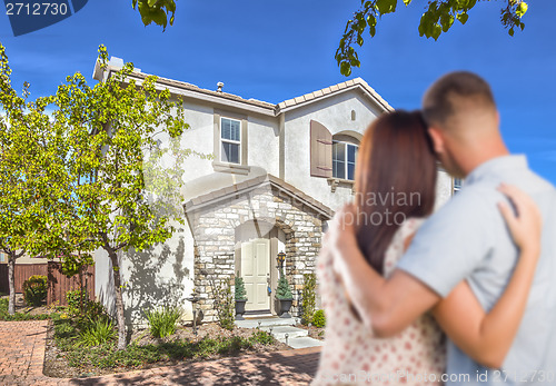 Image of Military Couple Looking at Nice New House