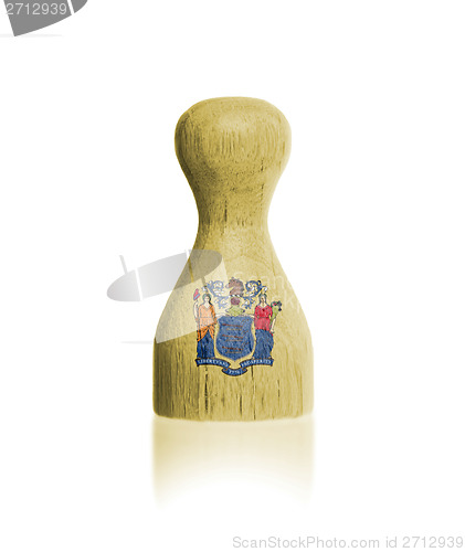 Image of Wooden pawn with a painting of a flag