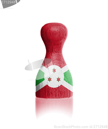 Image of Wooden pawn with a painting of a flag