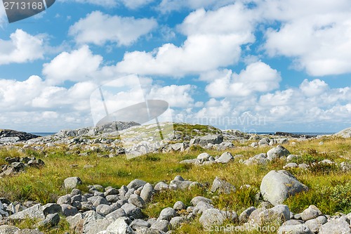 Image of Stony landscape with blue sky with white clouds.