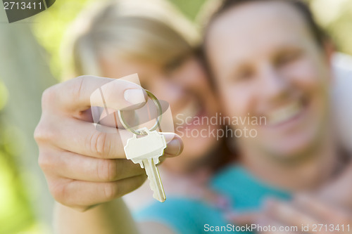 Image of Happy Couple Holding Blank House Key Outside