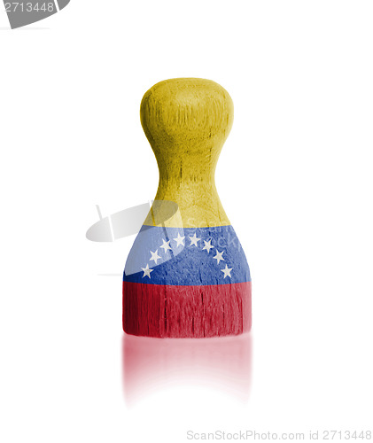 Image of Wooden pawn with a flag painting