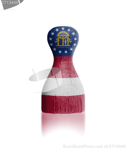 Image of Wooden pawn with a flag painting