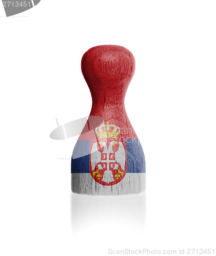 Image of Wooden pawn with a flag painting