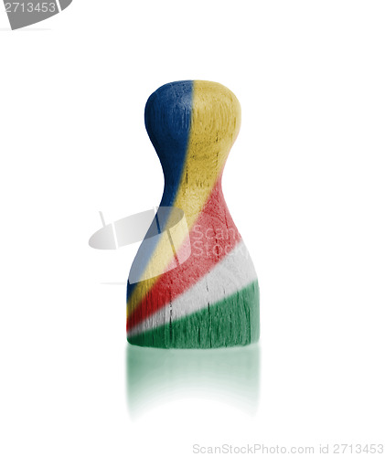 Image of Wooden pawn with a flag painting