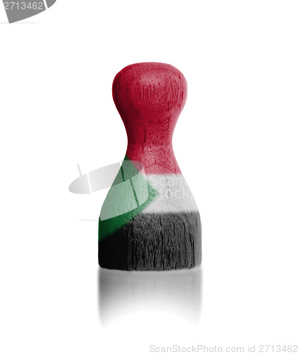 Image of Wooden pawn with a flag painting