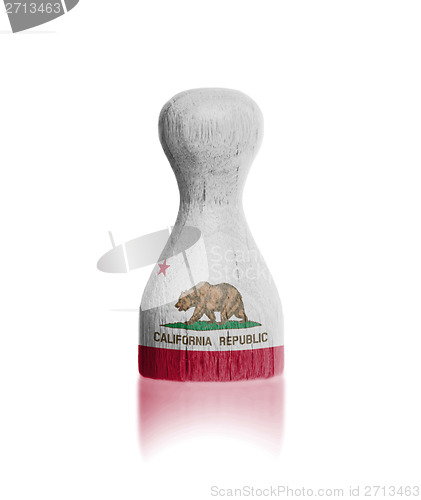 Image of Wooden pawn with a flag painting