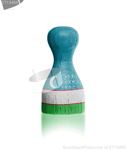 Image of Wooden pawn with a flag painting