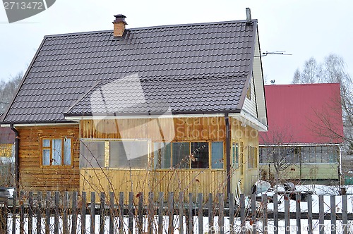 Image of The wooden house in a housing estate.