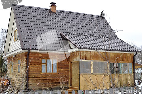 Image of The wooden house in a housing estate.