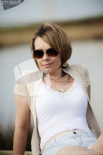 Image of woman next to lake
