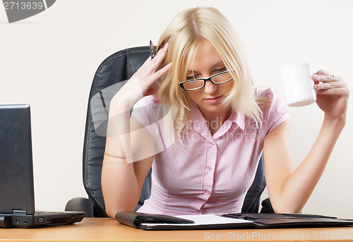 Image of Portrait of tired businesswoman with organizer
