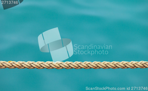 Image of Thick ship rope on the sea water background