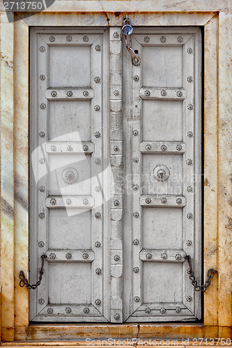 Image of Agra, India. The old gray wooden door