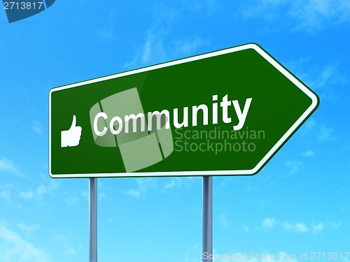 Image of Social network concept: Community and Thumb Up on road sign background