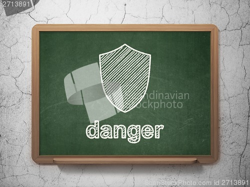 Image of Privacy concept: Shield and Danger on chalkboard background