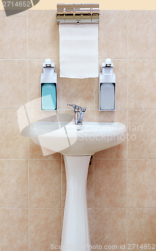 Image of Washbasin with a paper towel and liquid soap