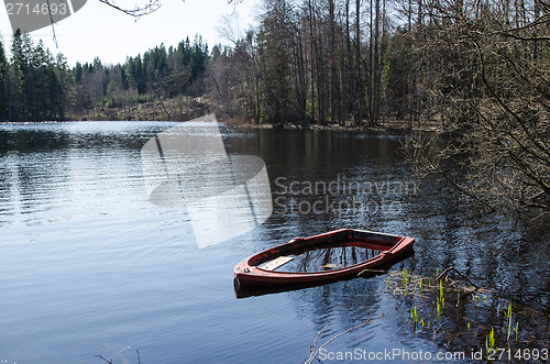 Image of Water filled rowboat