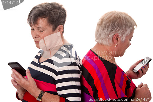 Image of Two senior women reading SMS