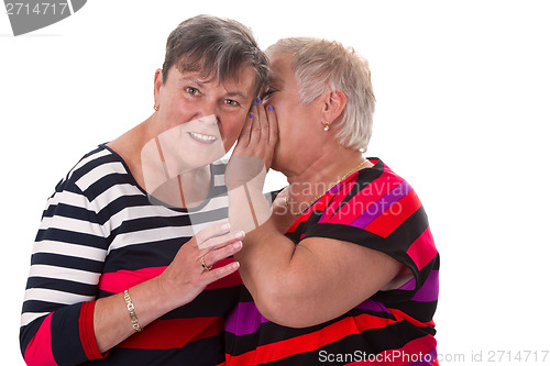 Image of Two senior women whispering