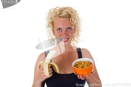 Image of Young woman with banana and cornflakes