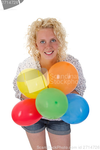 Image of Young woman holding balloons