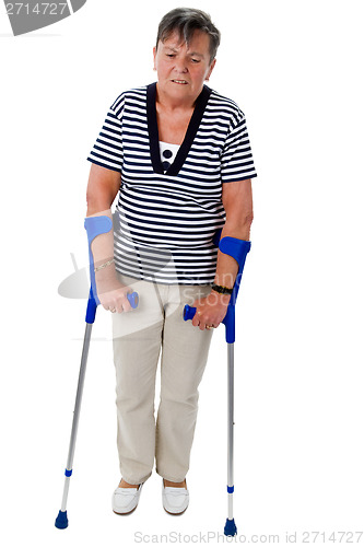Image of Old woman walking on crutches